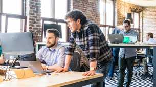 Photo of people discussing in an office