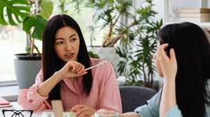 Photo of two people discussing cloth